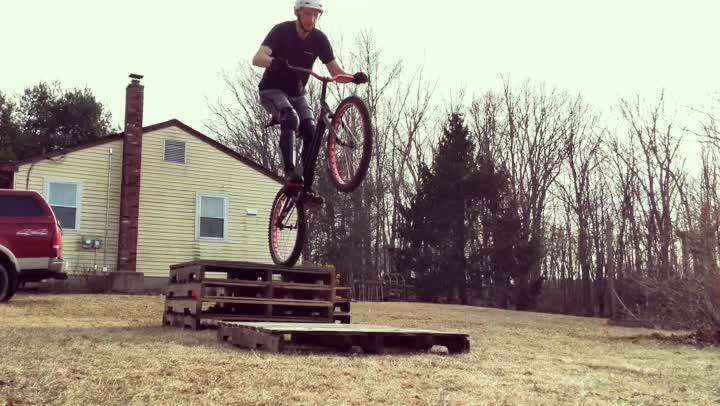 Trials biking - drop gap off a stack of pallets