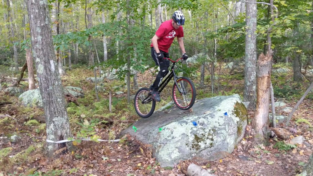 Trials biking competition - riding on a boulder