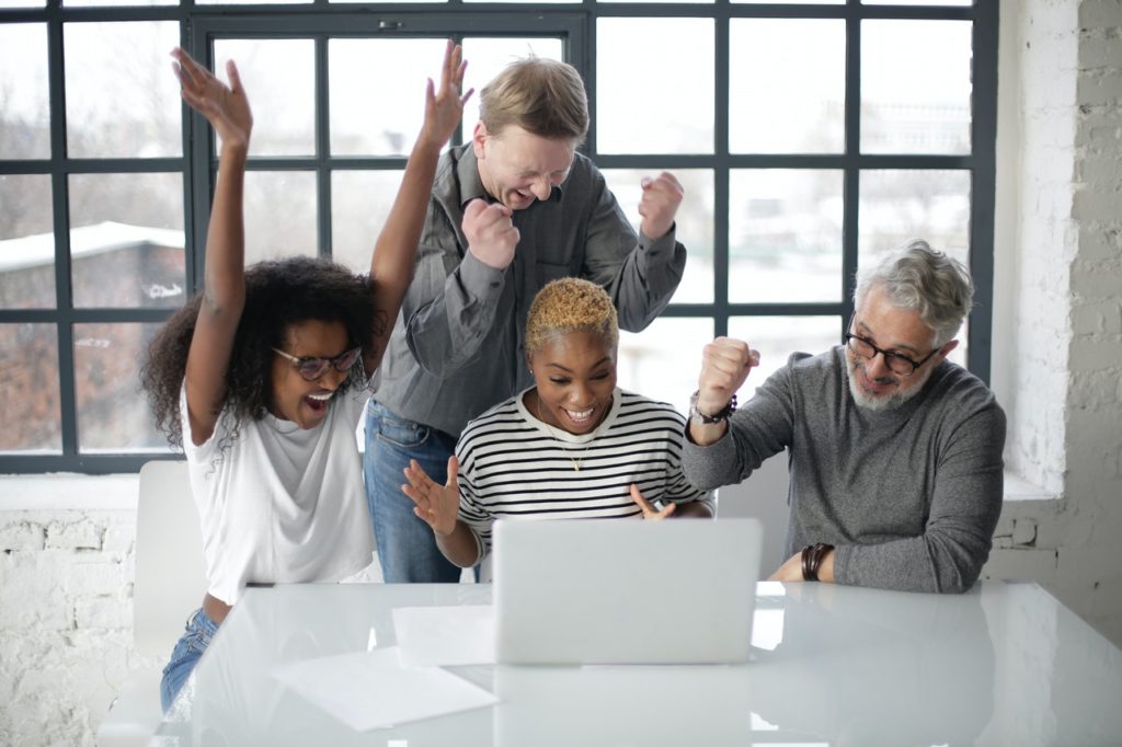 Team celebrating victory in an office