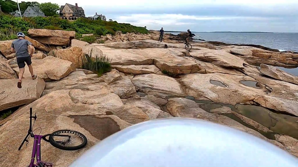 Trials bike riders on the rock ledge of the Narragansett, RI shoreline