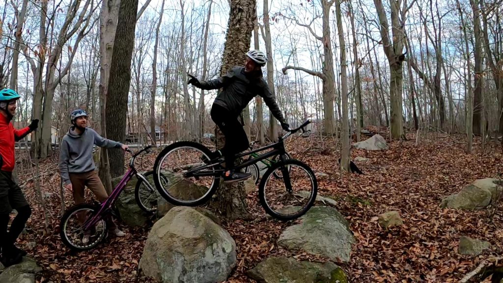 Tony pauses, leaning against a tree with his trials bike perched atop two rocks, telling the crew to hang on a moment.